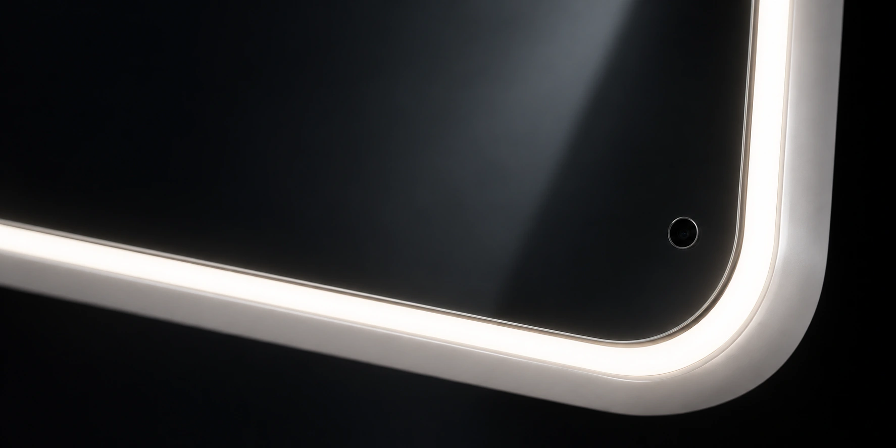 Macro studio view of Poréa’s continuous illuminated surround curving around the reflective glass and a discreet camera